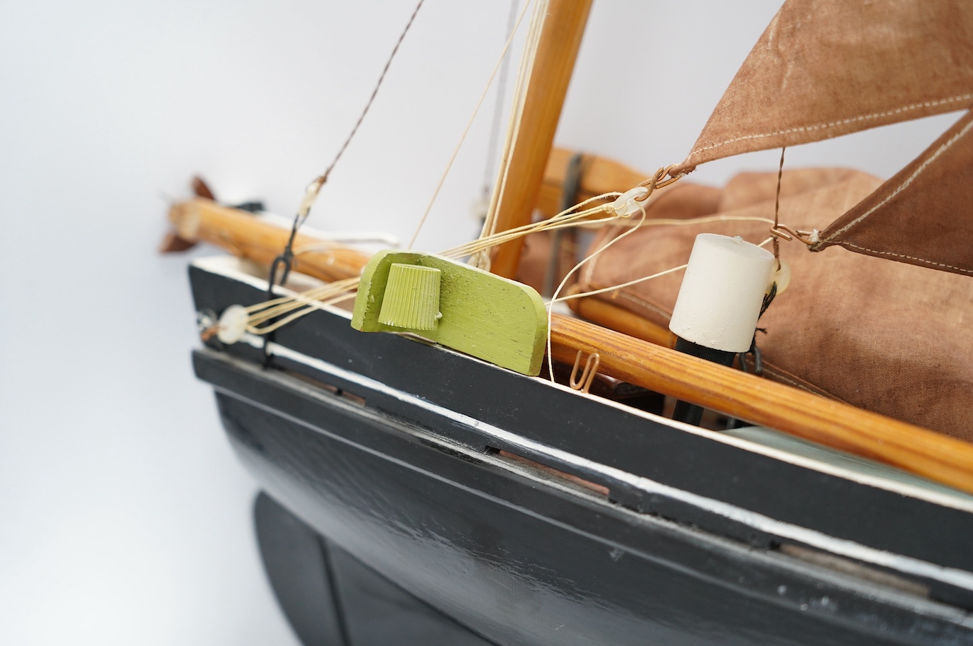 A painted wood pond yacht, 77cm in length. Condition - one mast broken